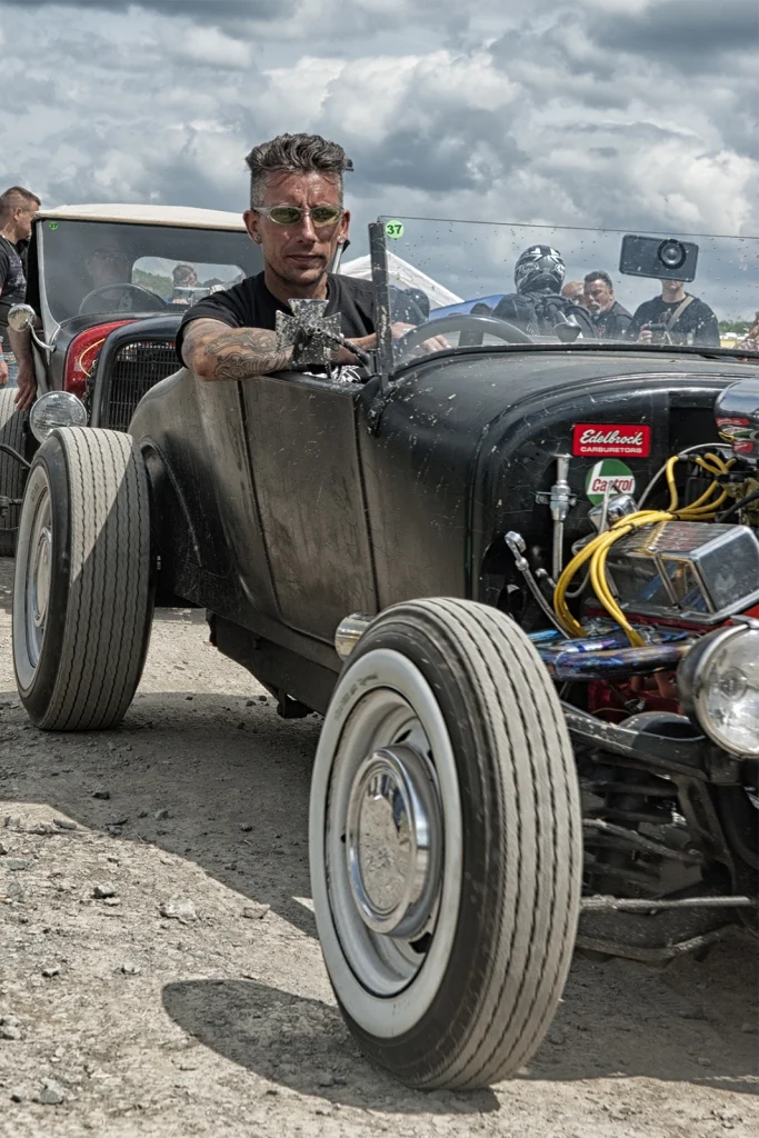 Pilote au volant d'un hot rod noir, roue avant en gros plan, Hot Rod Custom Show Chimay