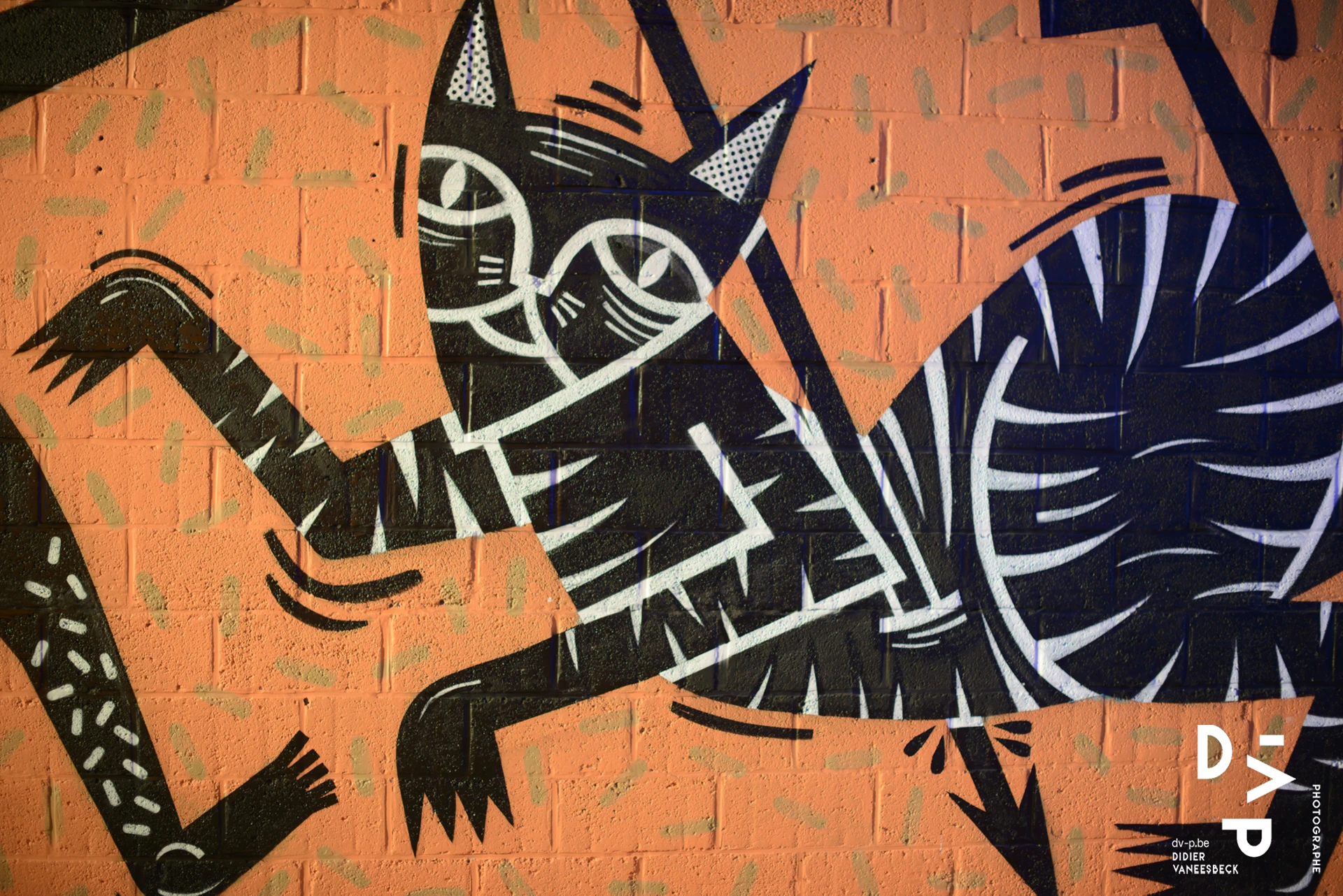 Fresque d'un chat stylisé noir sur fond orange – Strokar Inside, Bruxelles 2018